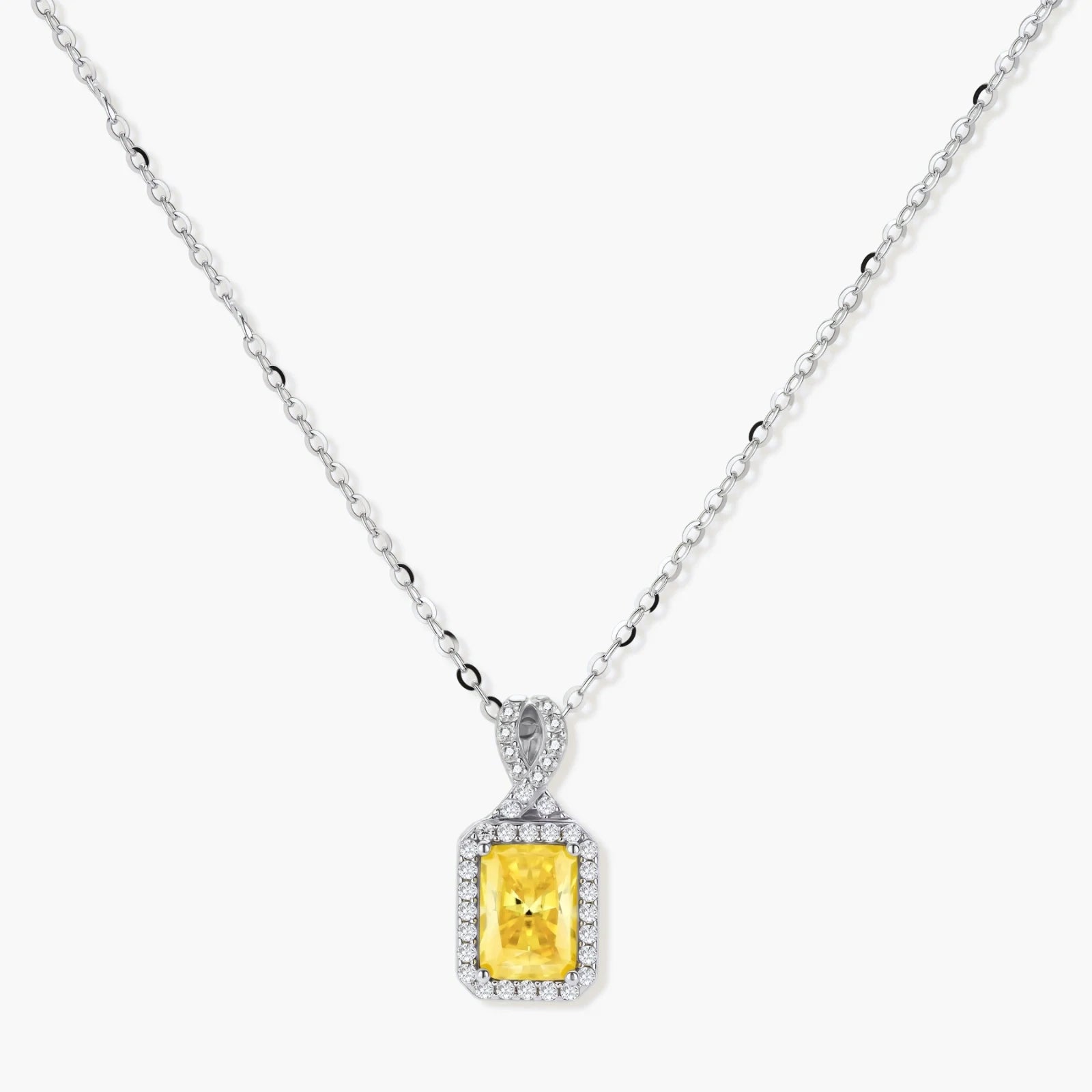 Yellow moissanite jewelry set with emerald-cut stones in sterling silver halo settings on white background.