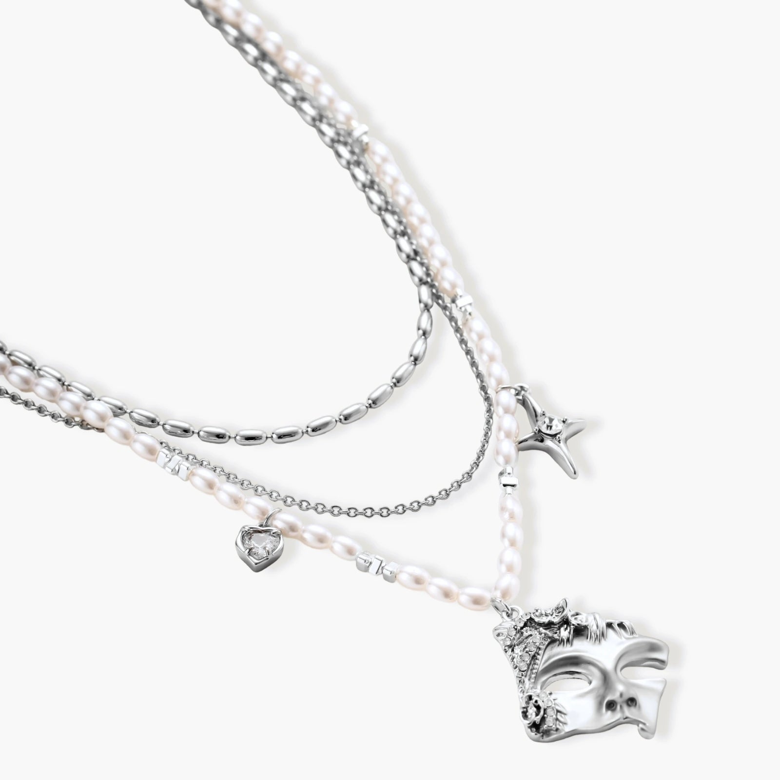 Multi-strand layered necklace set with silver chains, white pearls, star charm, heart pendant, and ornate decorative piece