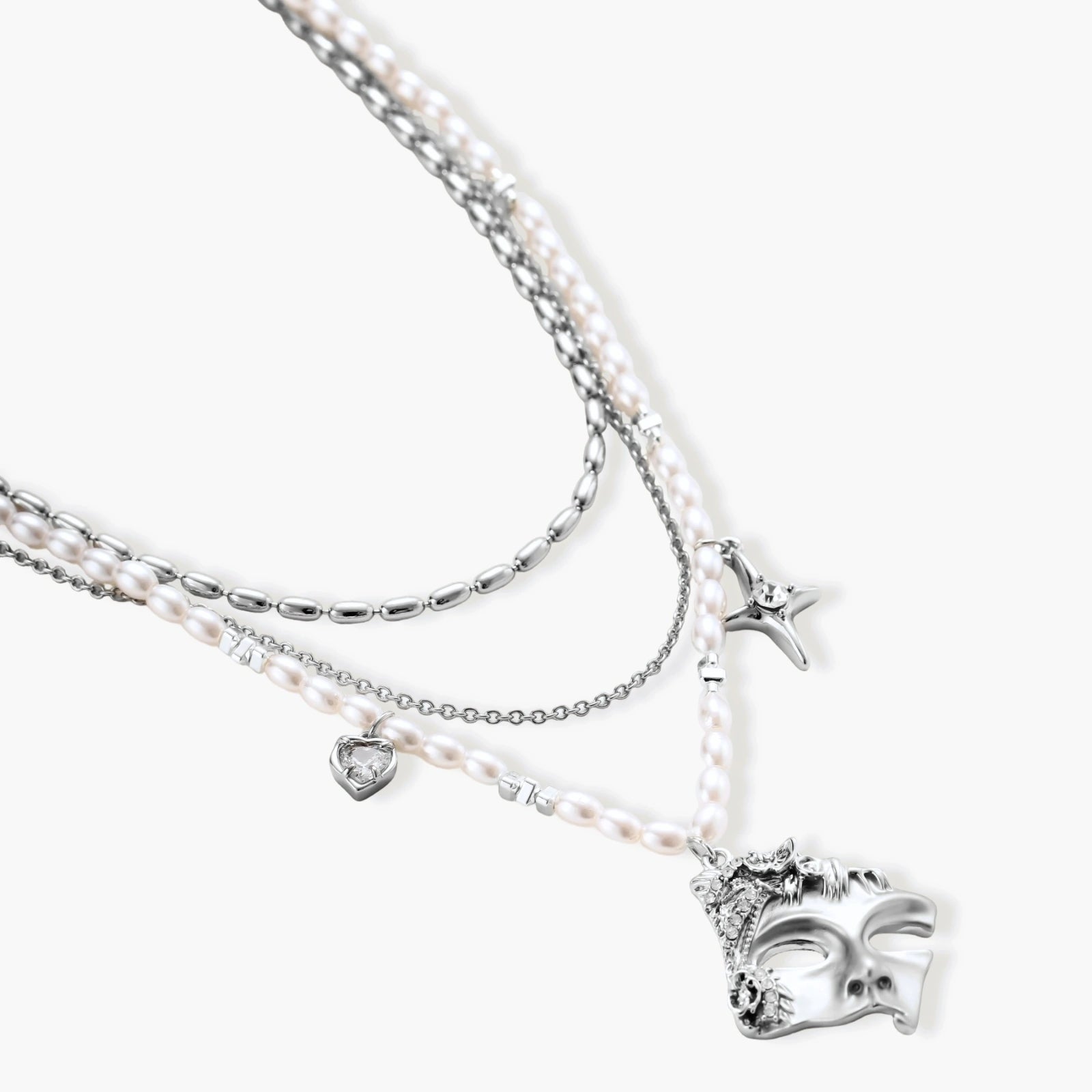 Ornate silver-toned masquerade mask jewelry set featuring rhinestone details and pearl drop earrings on white background.