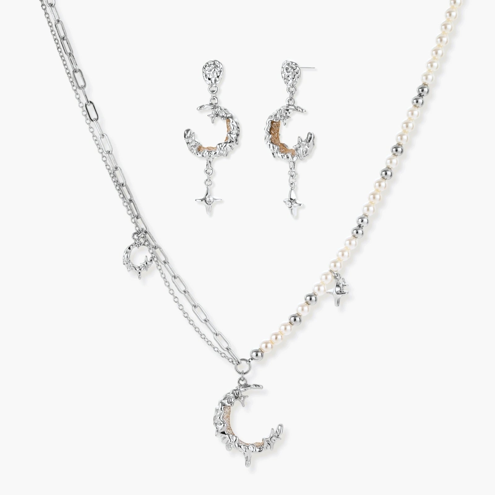 Mixed-metal jewelry set featuring layered necklaces with crescent moon pendant and pearl beads, plus matching star-drop earrings.