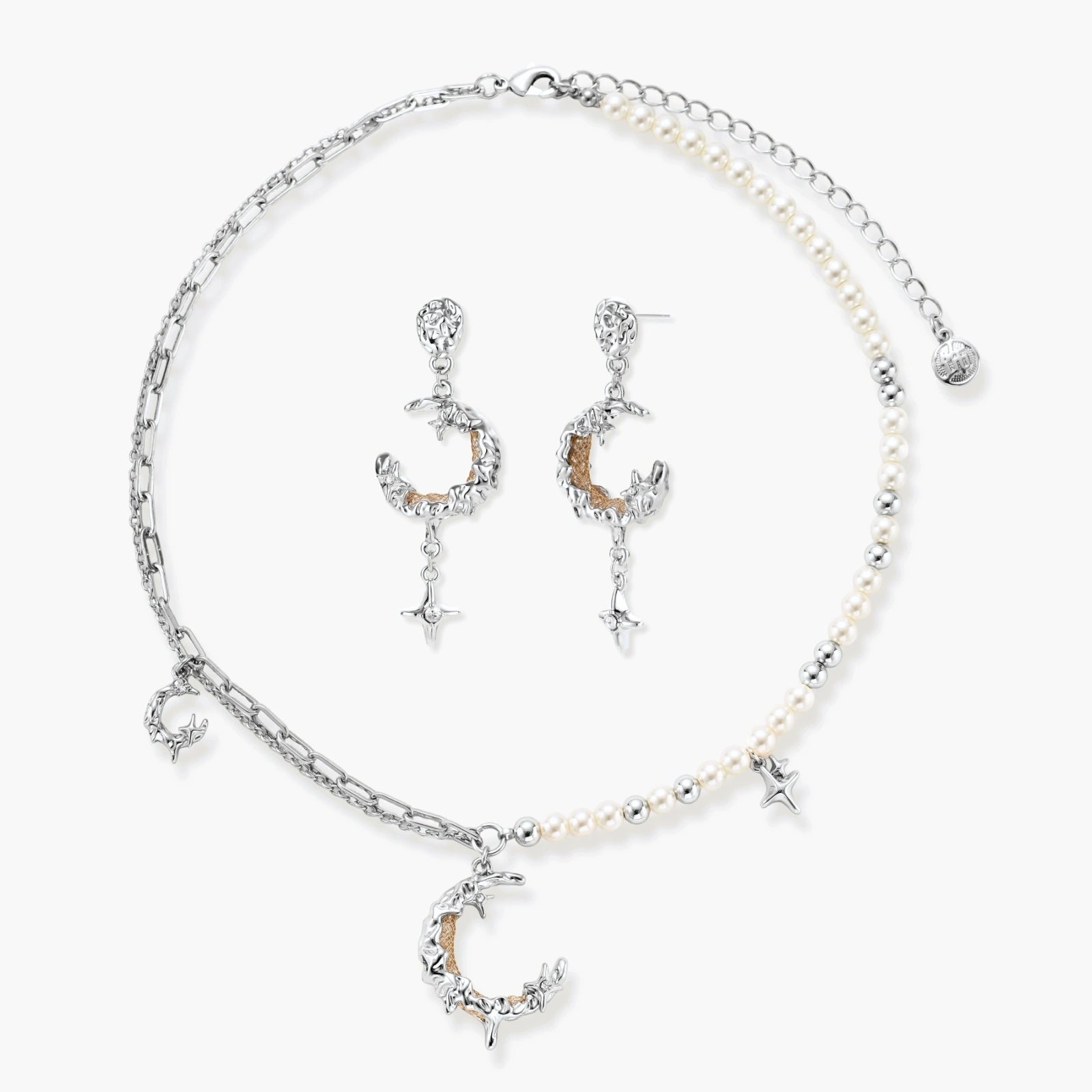 Mixed-metal jewelry set featuring layered necklaces with crescent moon pendant and pearl beads, plus matching star-drop earrings.