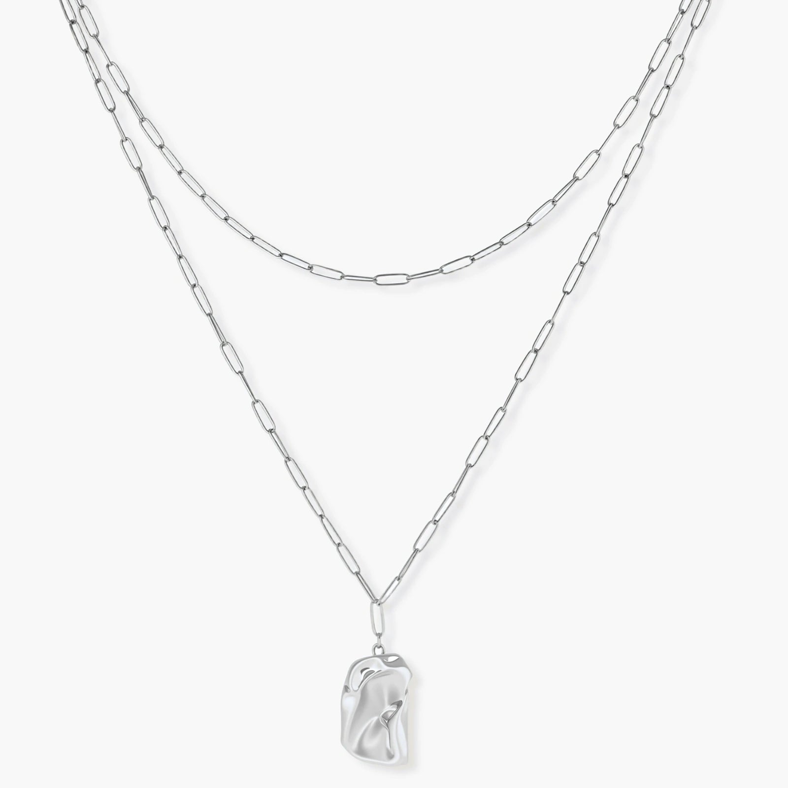 Silver layered necklace with organic flowing pendant in eco-zinc alloy on neutral background, showing adjustable chain design.