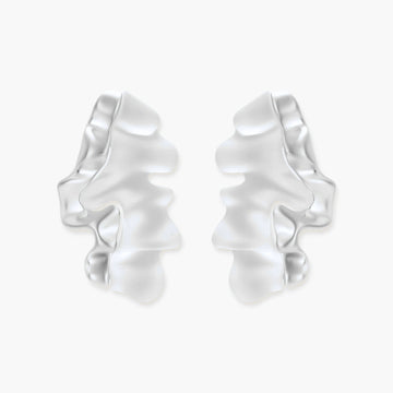 Pair of silver-toned sculptural earrings with flowing abstract forms and stud backs against white background.